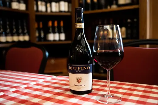 Bottiglia di Chianti e calice sul tavolo